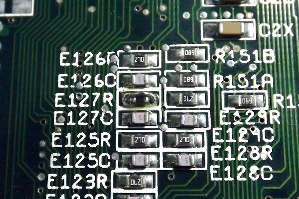 Bottom side of Amiga 1200 mainboard. E127 element shorted with a wire.